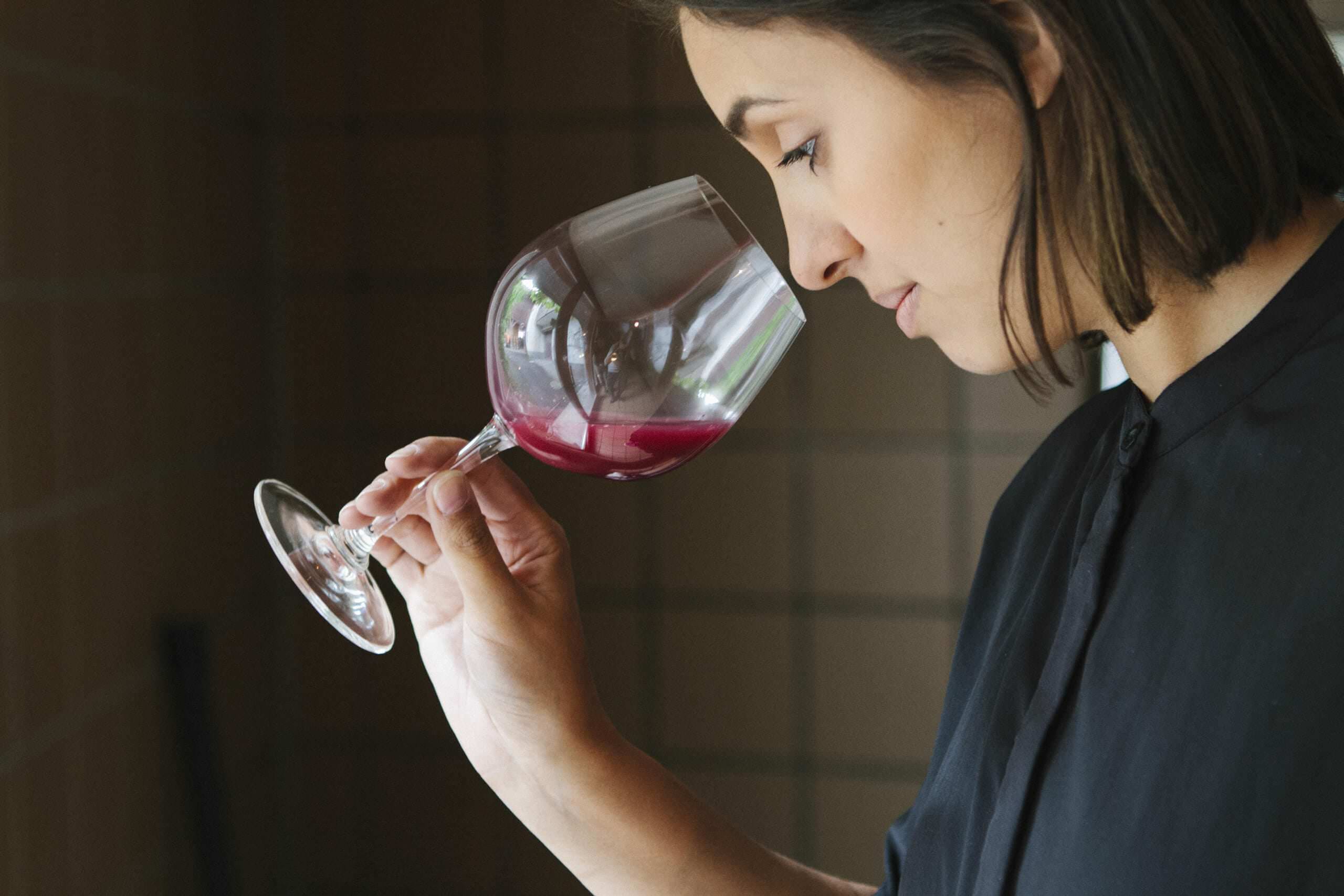 Sommelier Amanda Bulgin tasting red wine from winemaker Donatsch, Switzerland